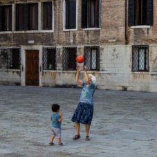 woman playing with child using basketball