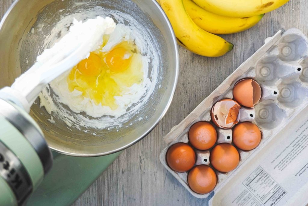 Mixing eggs, flour and bananas.