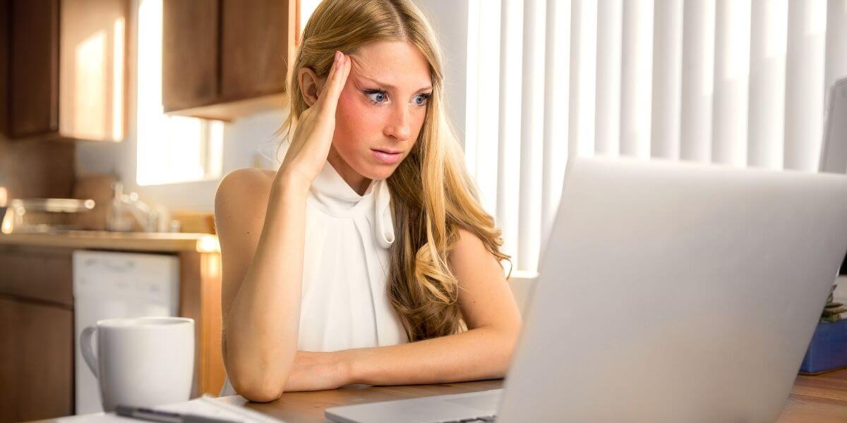 Picture of a stressed out woman looking at the laptop