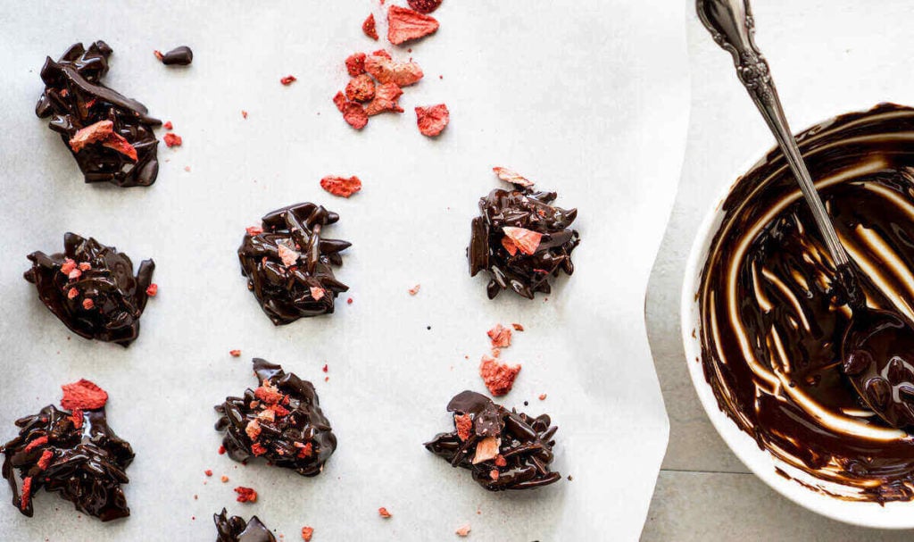 Step 4 is to sprinkle the strawberry flakes and salt over the dark chocolate keto clusters