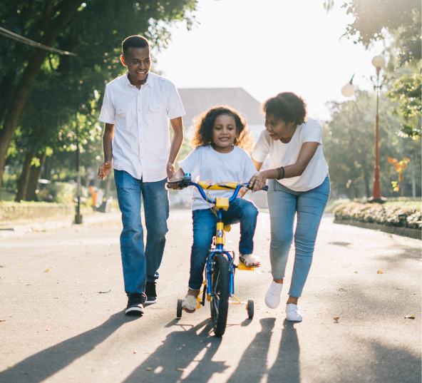 Picture of a family helping their child bike